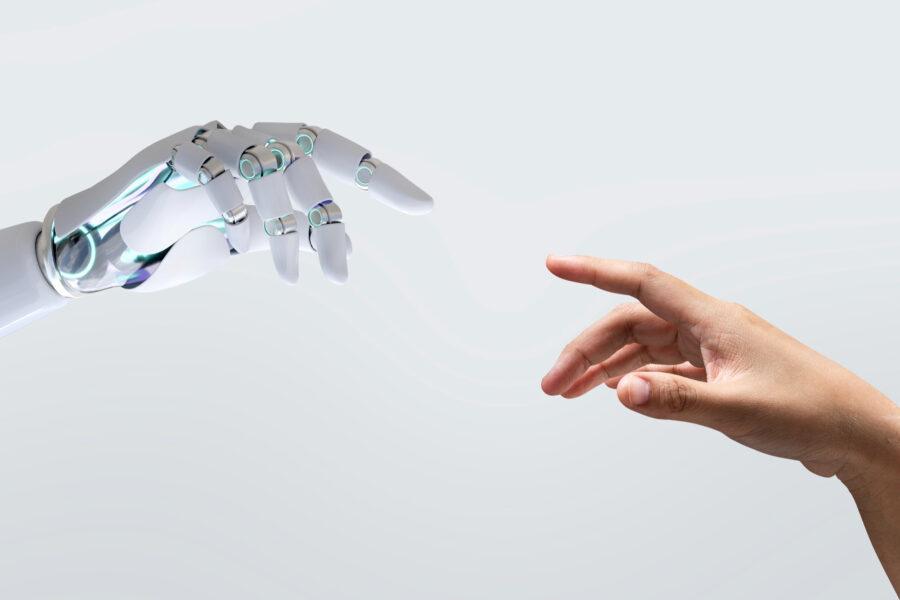 Main humaine et main robotique se rapprochant comme sur l'oeuvre de michel-ange, représentant la connexion entre IA et humain